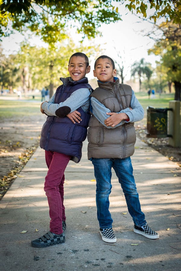 portrait kids posing back to back
