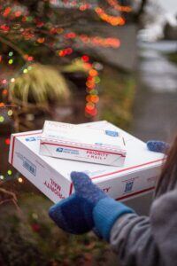 person carrying package for holidays