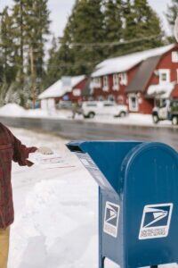person mailing package for holidays